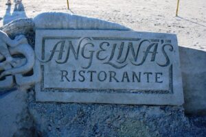 Restaurant logo sculpted in sand